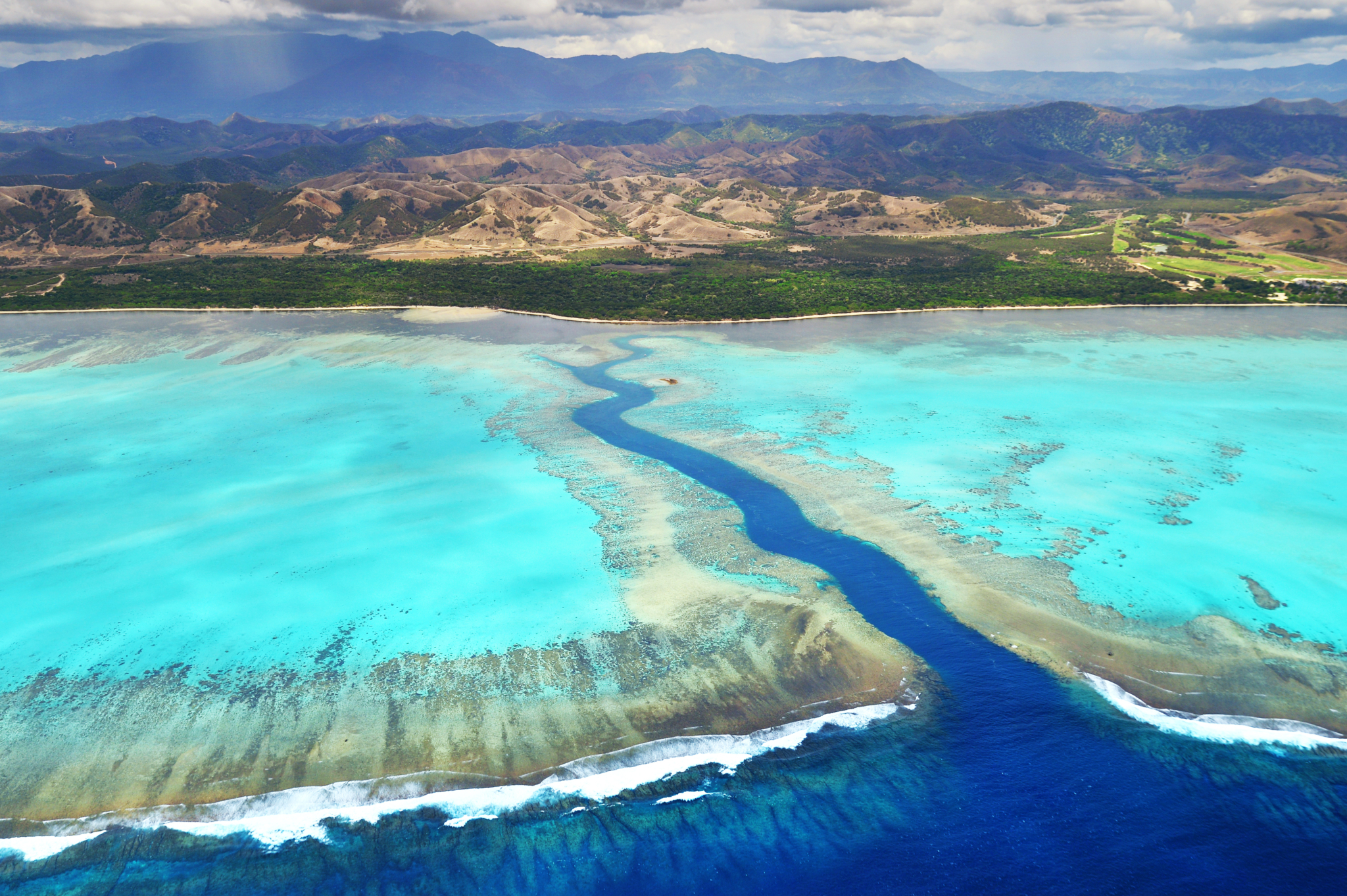 Aerial view corals reef and mountains in New Caledonia